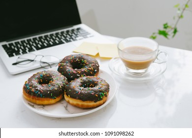 Food In The Office. Donuts On Working Desk.