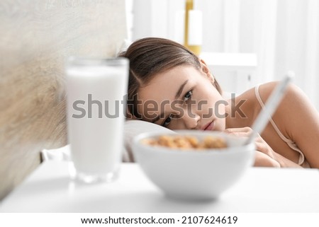 Food on table in bedroom of young woman. Anorexia concept