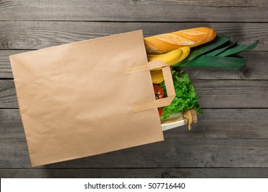 Food In Paper Bag On Wooden Background. Grocery Shopping Concept, Top View