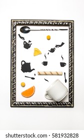 Food photo with candies and black flat objects from black paper