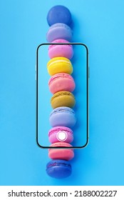 Food photo, food photography concept with French macarons in smartphone screen viewfinder. Vertical photography.
