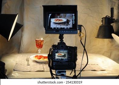 Food Photographer With Camera And Monitor. 
