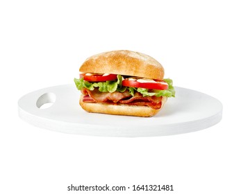 Food photography of a bread roll BLT with bacon, lettuce, tomato and mayonnaise on a white wooden board on a white background