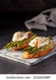 Food Photography Of Bruschetta, Toast With Poached Egg, Asparagus, Prosciutto, Avocado