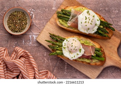 Food Photography Of Bruschetta, Toast With Poached Egg, Asparagus, Prosciutto, Avocado