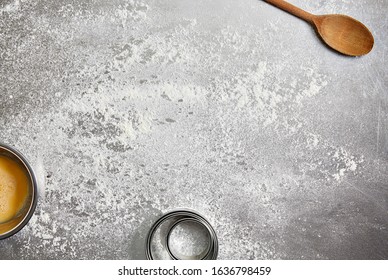 Food photography of a metal kitchen surface with flour and other baking equipment and ingredients - Powered by Shutterstock