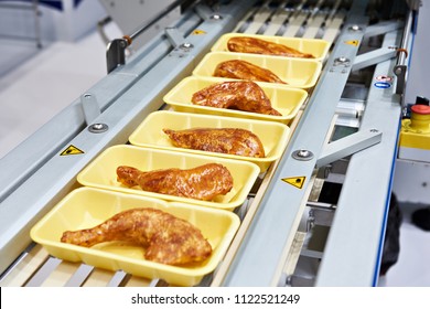 Food Products Meat Chicken In Plastic Packaging On The Conveyor