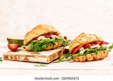 Food recipe background. Close up Breakfast, business lunch, sandwiches Croissant with strawberries and soft cheese with mold brie camembert. banner menu recipe top view.