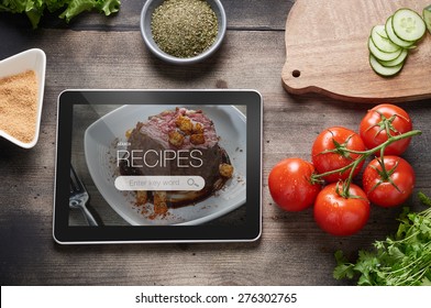 Food Recipes Tablet Computer On Rustic Wooden Table