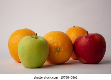 Food Related: Apples and Oranges on a White Background