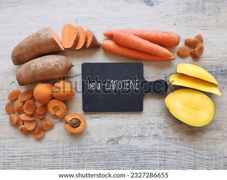 Food rich in beta carotene with text Beta Carotene. Various fruits and vegetables as natural sources of beta carotene. It is an organic red-orange pigment abundant in plants.