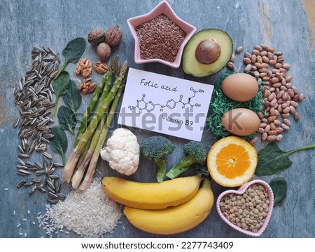 Food rich in folic acid (vitamin B9) with structural chemical formula of folic acid. Natural food sources of vitamin B9. Natural products containing folic acid. Asparagus, avocado, broccoli, nuts, egg