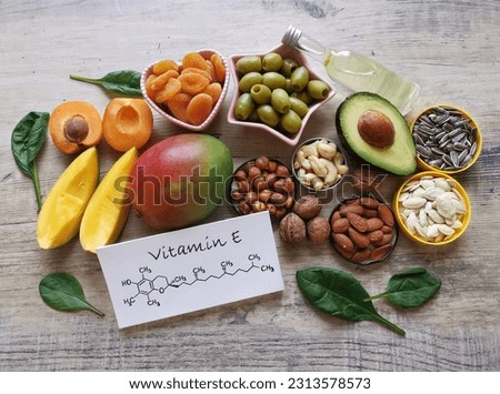 Food rich in vitamin E with structural chemical formula of vitamin E molecule. Natural products containing vitamins, dietary fiber and minerals. Healthy sources of tocopherol, healthy diet food.