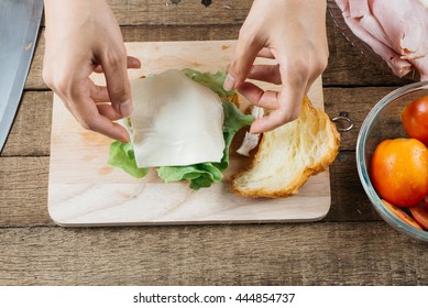 Food Series : Making Croissant Sandwich, Woman's Hand Placing Cheese On Croissant Sandwich