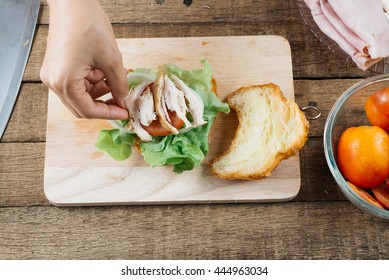 Food Series : Making Croissant Sandwich, Woman's Hand Placing Boiled Chicken Breast On Croissant Sandwich