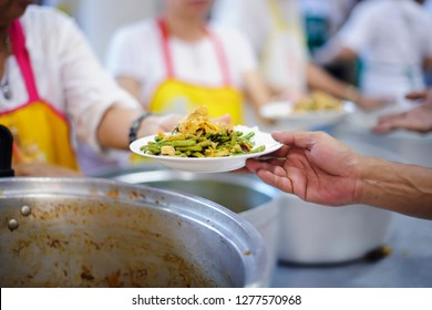 Food sharing in human societies can help homeless people, beggars. - Shutterstock ID 1277570968