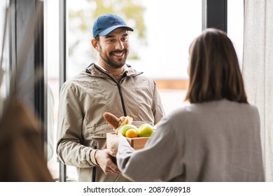 Food Shipping And People Concept - Happy Delivery Man Giving Wooden Box With Groceries To Female Customer At Home