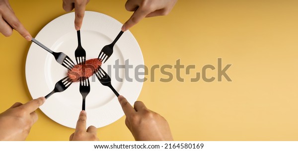 Food Shortage, World Food Crisis Concepts.\
Inflation, Fuel Price and Environmental Impact. Global Issues in\
Agricultural and Climate Change. Group of Hungry People Snatched a\
Tiny Steak by Fork