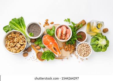 Food Sources Of Omega 3 And Omega 6 On White Background Top View. Foods High In Fatty Acids Including Vegetables, Seafood, Nut And Seeds