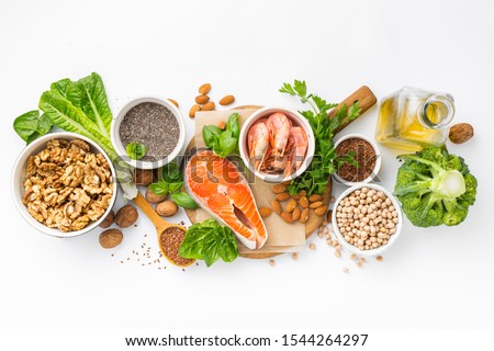 Food sources of omega 3 and omega 6 on white background top view. Foods high in fatty acids including vegetables, seafood, nut and seeds