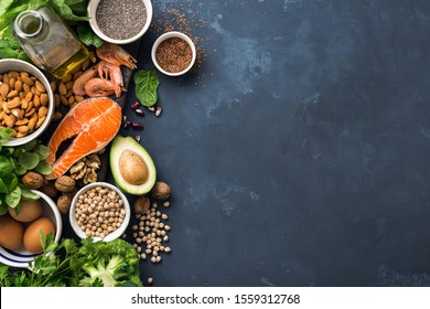 Food sources of omega 3 and healthy fats on dark background top view. Copy Space. Vegetables, seafood, nut and seed - Shutterstock ID 1559312768