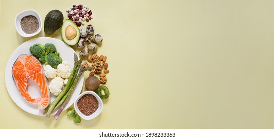 Food Sources Of Omega 3 On A Yellow Background. Fresh Vegetables, Fish, Seeds And Nuts, Healthy Food Concept