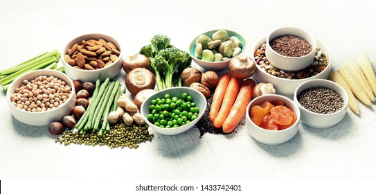 Food sources of plant based protein. Healthy diet with  legumes, dried fruit, seeds, nuts and vegetables.  Foods high in protein, antioxidants, vitamins and fiber. Panorama, banner
