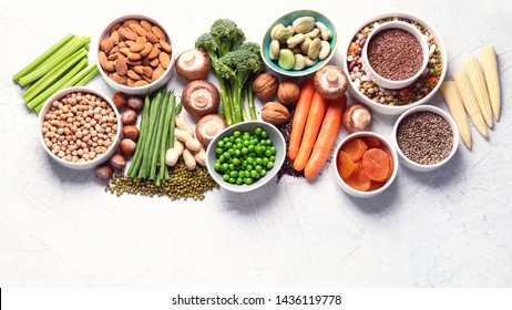 Food sources of plant based protein. Healthy diet with  legumes, dried fruit, seeds, nuts and vegetables.  Foods high in protein, antioxidants, vitamins and fiber. Image with copy space. Top view