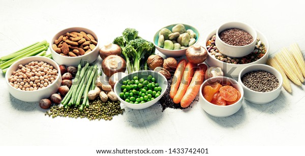 Food\
sources of plant based protein. Healthy diet with  legumes, dried\
fruit, seeds, nuts and vegetables.  Foods high in protein,\
antioxidants, vitamins and fiber. Panorama,\
banner