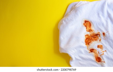 Food Stains On Shirt. Top View Tomato Sauce Dirt On White Shirt. Space For Text.