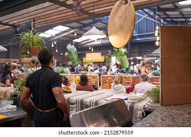 A Food Stall Owner Waits For Customers At His Taco Stall At A Busy Market