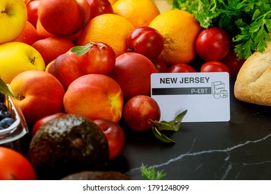 Food Stamps Card On Table With Fruits. Food Benefits Concept.