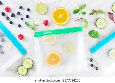 Food Storage Bags With Fruit And Vegetables, Overhead Flat Lay Shot On A White Marble Kitchen Table. Fresh Summer Produce In Ziplock Containers