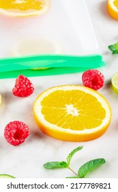 Food Storage Bags With Fruit And Vegetables, On A White Marble Kitchen Table. Fresh Summer Produce In Ziplock Containers