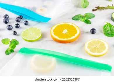 Food Storage Bags With Fruit And Vegetables, On A White Marble Kitchen Table. Fresh Summer Produce In Ziplock Containers