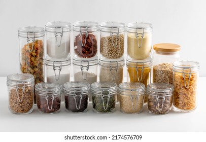 food storage, culinary and storage concept - jars with different cereals or groceries on table