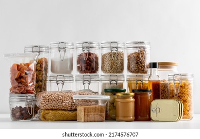 food storage and eating concept - close up of different cereals, groceries and preserves on table