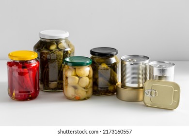 Food Storage, Eating And Preserve Concept - Close Up Of Jars And Tin Cans With Preserves On Table