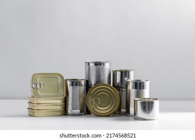 Food, Storage And Preserve Concept - Close Up Of Tin Cans With Preserves On Table