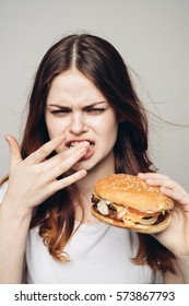 The Food Stuck In The Teeth, A Woman With Burger In Hand..