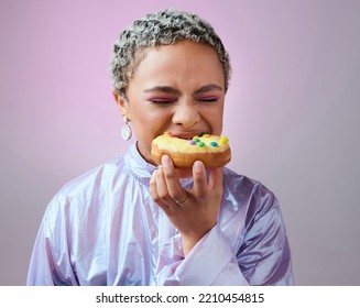 Food, Studio And Woman Is Eating A Donut Cake With Eyes Closed Enjoying Sweet Icing And Sugar Pastry Alone. Hungry Young Girl On A Fast Food Diet With A Big Bite On A Doughnut Snack As A Cheat Meal