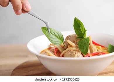 Food Stylist Use Tweezers Decorating Thai Food In White Bowl