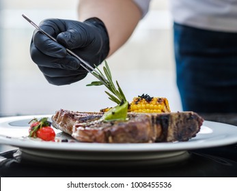 Food Stylist At Work. Decorating Meat Steak Meal. Culinary Art. Creative Arrangement