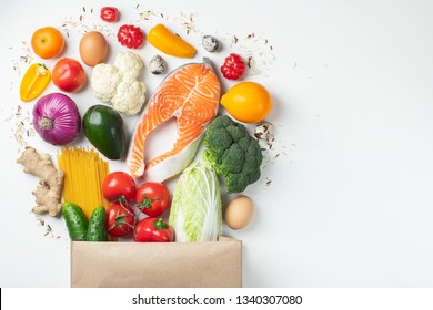 Food from the supermarket. Paper bag full of healthy food. Top view with copy space. Flat lay. - Shutterstock ID 1340307080