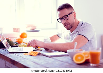 Food supplements. Bearded handsome athletic man leading healthy lifestyle studying info about food supplements - Powered by Shutterstock