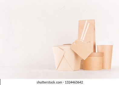 Food takeaway set mockup for brand - blank kraft paper pack for asian cuisine - box for noodles, label, drink cup, bowl, chopsticks on white wooden table.