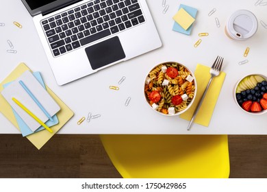 Food In Taking Away Boxes On White Table With Laptop. Online Food Delivery. New Normal Work From Home Concept.