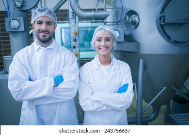 Food technicians smiling at camera in a food processing plant