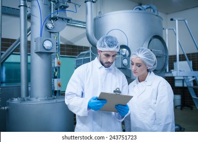 Food technicians working together in a food processing plant