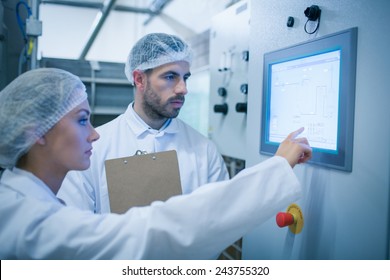 Food technicians working together in a food processing plant - Powered by Shutterstock